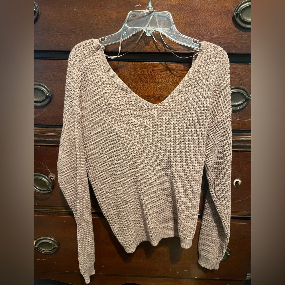 Cute sweater with a little fun in the back. Never been worn!